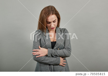 Bitting mouth and looking worried, scared crossing arms, worry, doubt. Thinking Bitting mouth and looking worried, scared crossing arms, worry, doubt. Thinking 70505815