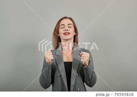 Clenching fists, grimacing as yells, either pain, temper, cheering someone on Clenching fists, grimacing as yells, either pain, temper, cheering someone on 70505816