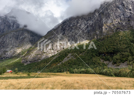 Village countryside in rocky hills. Mountains near Andalsnes in Norway Village countryside in rocky hills. Mountains near Andalsnes in Norway 70507673