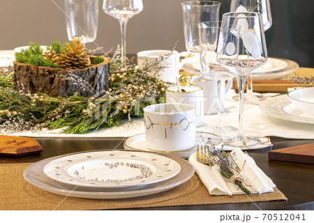 Elegant table set for Christmas dinner Elegant table set for Christmas dinner 70512041