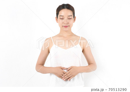 お腹を押さえる若い女性 70513290