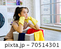 woman frustrated with washing clothes 70514301