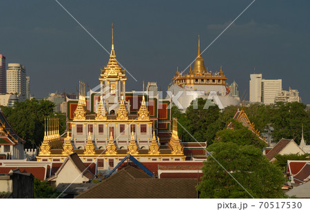 Loha Prasat Wat Ratchanatda and Golden Mountain pagoda, a buddhist temple or Wat Saket with skyscraper buildings in Bangkok Downtown, urban city, Thailand. Thai Landmark. Architecture. 70517530