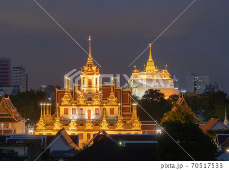 Loha Prasat Wat Ratchanatda and Golden Mountain pagoda, a buddhist temple or Wat Saket with skyscraper buildings in Bangkok Downtown, urban city, Thailand. Thai Landmark. Architecture. Loha Prasat Wat Ratchanatda and Golden Mountain pagoda, a buddhist temple or Wat Saket with skyscraper buildings in Bangkok Downtown, urban city, Thailand. Thai Landmark. Architecture. 70517533