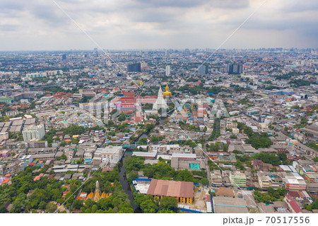 Aerial view of the Giant Golden Buddha in Wat Paknam Phasi Charoen Temple in Phasi Charoen district at sunset, Bangkok. Urban town, Thailand. Downtown City. 70517556