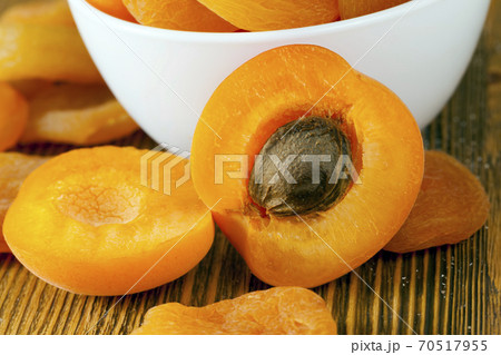 cut apricots in a glass white bowl 70517955