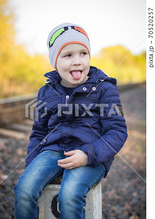A small pre-school boy plays on the railway without supervision from adults. Railway - a zone of increased danger	 70520257