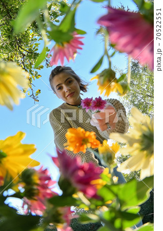 Young Girl with Bouquet Below View of Flowers 70522551
