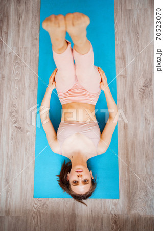 top view. girl does yoga exercises at home. 70523070
