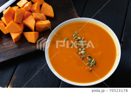 Homemade pumpkin soup on a black table 70523178