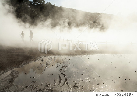 Thermal pools with mist rising from the heated water pools 70524197