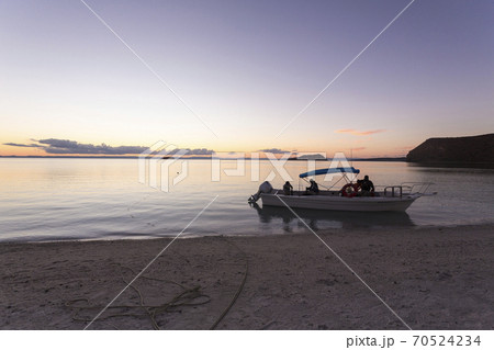 Power boat moored near beach at sunset, Sea of Cortes Power boat moored near beach at sunset, Sea of Cortes 70524234