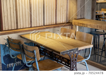 Reclaimed wood and metal vintage table and chairs in a pub. 70524478