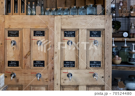 Close up of wooden dispensers for cleaning products in a waste free wholefood store. 70524480