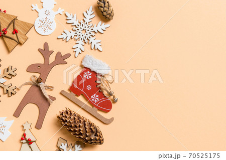 Top view of New Year toys and decorations on orange background. Christmas time concept with empty space for your design 70525175