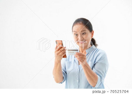 スマホとカードを持つシニア女性 スマホとカードを持つシニア女性 70525704