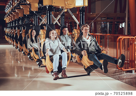 Man smiles while sitting and holding onto seat. 70525898