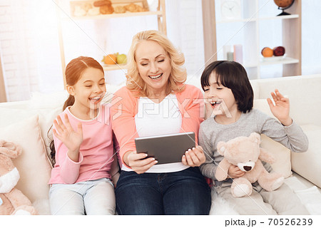 Joyful young grandmother with grandchildren. Joyful young grandmother with grandchildren. 70526239