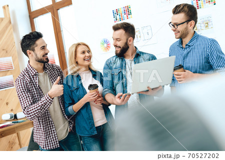 Team of designers architects look at laptop. 70527202