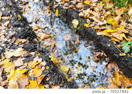 rain puddle in deep rut on country road in autumn rain puddle in deep rut on country road in autumn 70527892