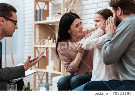 Young couple tries to reach out to small daughter. Young couple tries to reach out to small daughter. 70528190