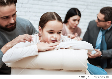 Dad tries to talk with his daughter in the office. 70528516