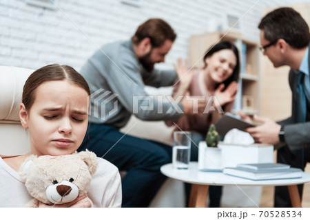 Teen scared for mom and holds a teddy bear. 70528534