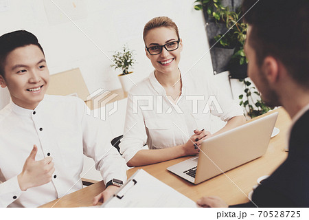 People sit at table at job interview in office. 70528725