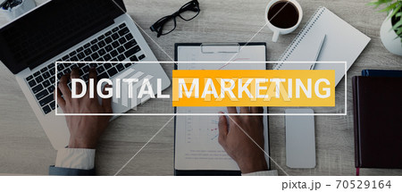 African Businessman At Laptop Working On Business Marketing Strategy Indoors 70529164