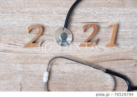 2021 Happy New Year for healthcare, Wellness and medical concept. Stethoscope and wooden number on table background 70529794
