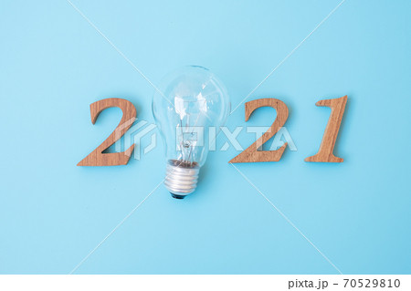 2021 Happy New year with lightbulb with and wooden number. New Start, Idea, Creative, Innovation, Resolution, Solution, Strategy, Goals and Mission concept 2021 Happy New year with lightbulb with and wooden number. New Start, Idea, Creative, Innovation, Resolution, Solution, Strategy, Goals and Mission concept 70529810