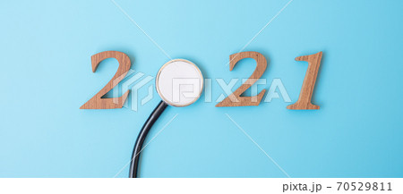 2021 Happy New Year for healthcare, Wellness and medical concept. Stethoscope and wooden number on blue background 2021 Happy New Year for healthcare, Wellness and medical concept. Stethoscope and wooden number on blue background 70529811