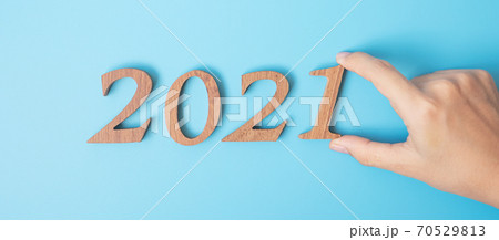 hand change 2020 to 2021 number on blue background. Resolution, strategy, solution, goal, Mission, business, New Year New You and happy holiday concepts 70529813