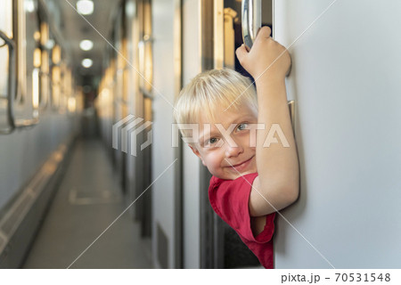 Portrait of child on train. Traveling with children by train. Portrait of child on train. Traveling with children by train. 70531548