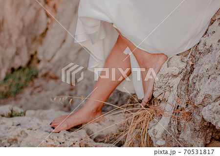 Girl's feet on the grass. Girl's feet on the grass. 70531817