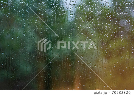 Water droplets on a window. Blurry blue and green background Water droplets on a window. Blurry blue and green background 70532326