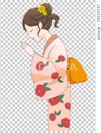 A woman in a kimono praying with her hands together A woman in a kimono praying with her hands together 70533747