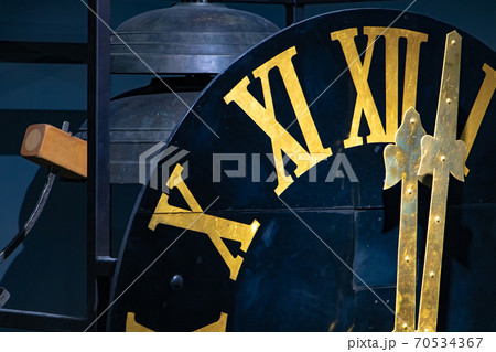 The clock with gilded Roman numerals shows twelve hours. The midnight on tower clock. The clock with gilded Roman numerals shows twelve hours. The midnight on tower clock. 70534367
