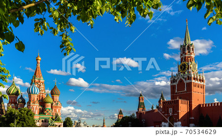 Moscow cityscape in summer, Russia. Panorama of Red Square in Moscow city center, beautiful view of St Basil’s Cathedral and Kremlin through foliage. 70534629