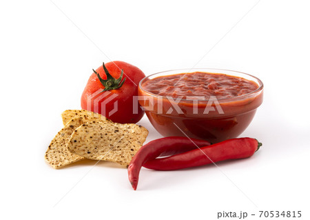 Spicy chili sauce in bowl with nacho chip isolated on white background 70534815