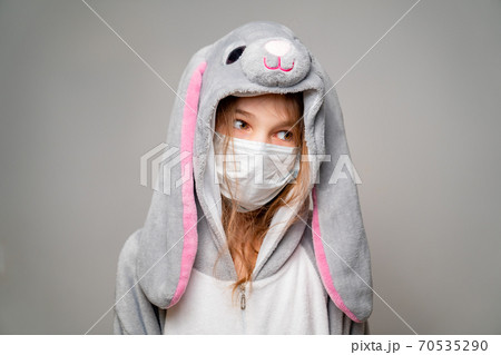 teen in kigurumi in medical mask. look away teen in kigurumi in medical mask. look away 70535290