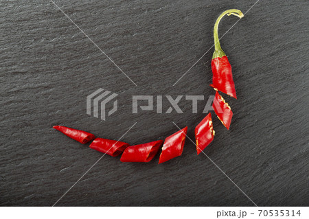 Red chili pepper on a black slate board. 70535314
