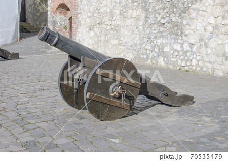 Old metal cannon on the wall of the fortress. 70535479