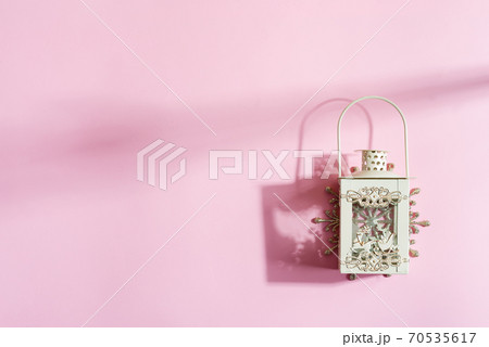 Creative Christmas lantern on a pastel pink background. Creative Christmas lantern on a pastel pink background. 70535617