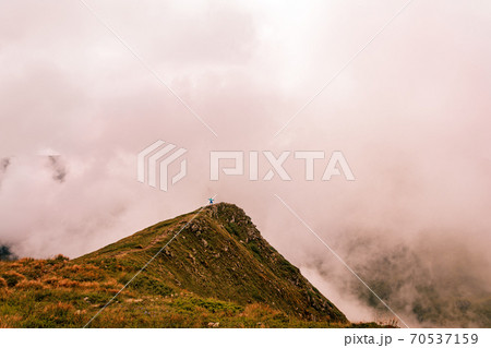 Montenegrin ridge in the clouds, Gutyn Tomnatyk mountain in the clouds, picturesque and fascinating magical landscapes from the mountain to the valleys. Montenegrin ridge in the clouds, Gutyn Tomnatyk mountain in the clouds, picturesque and fascinating magical landscapes from the mountain to the valleys. 70537159