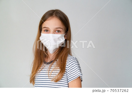 a teenager girl in medical mask white background a teenager girl in medical mask white background 70537262
