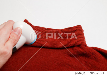 Device for removing lint from wool clothes. Golf with fuzz ball isolated on white background. Device for removing lint from wool clothes. Golf with fuzz ball isolated on white background. 70537351