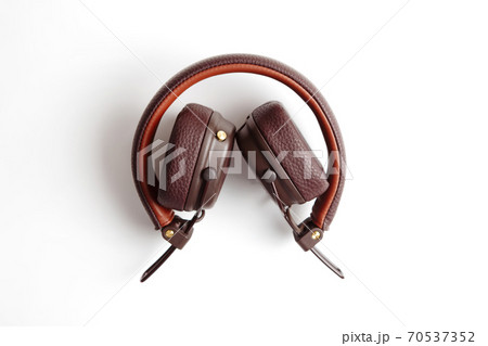 Modern brown leather wireless folded headphones isolated on white Modern brown leather wireless folded headphones isolated on white 70537352
