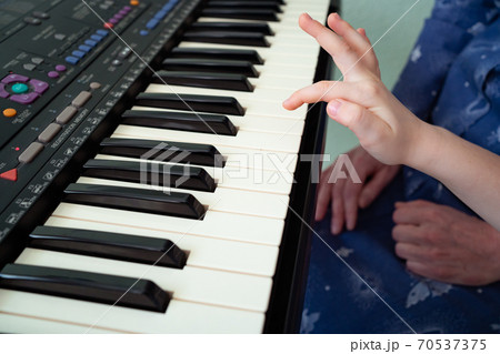 little hands black white piano keys synth close-up 70537375