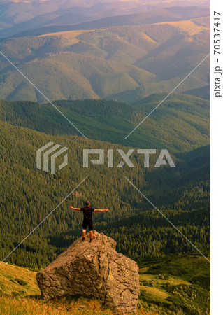 The top of Mount Pip Ivan, a tourist admires the scenery from the top, a hike in the Ukrainian Carpathians, fascinating epic photos. The top of Mount Pip Ivan, a tourist admires the scenery from the top, a hike in the Ukrainian Carpathians, fascinating epic photos. 70537417